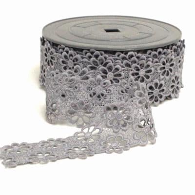 Embossed lace fabric grey with a purple appearence