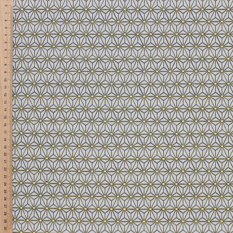Furniture fabric printed with small yellow origami patterns on a greige background