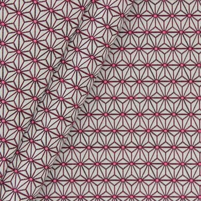 Furniture fabric printed with small fuschia origami patterns on a greige background
