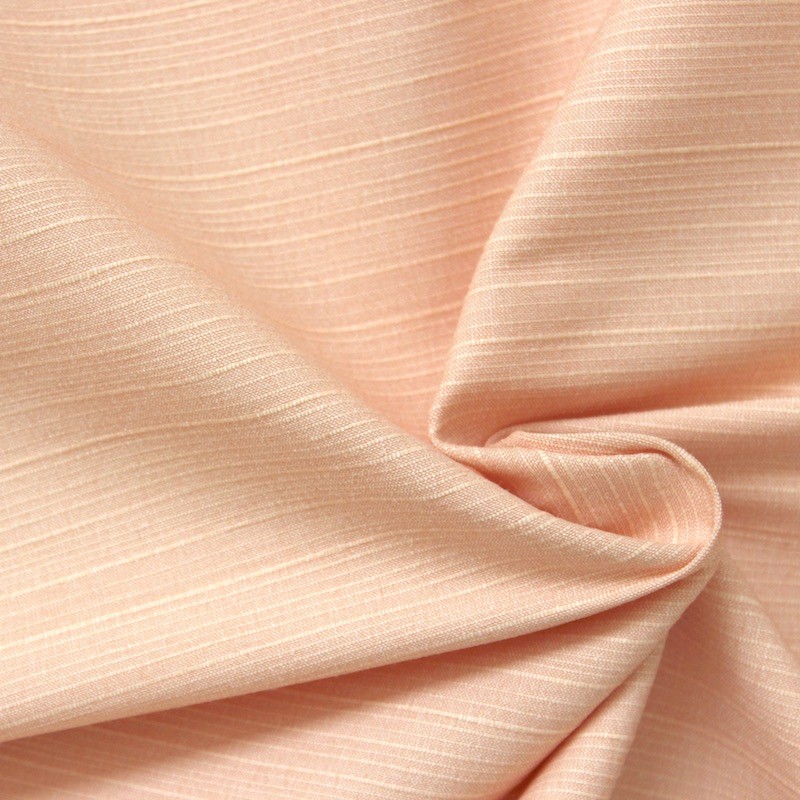 Tissu texturé rose saumon