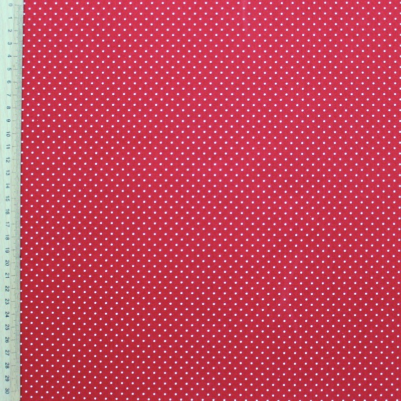 Tissu en coton à pois sur fond rouge