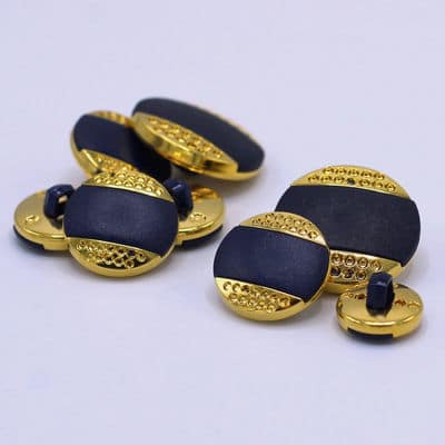 Round button with golden metal and navy blue aspect