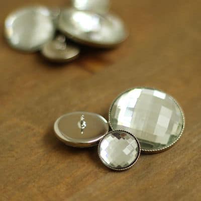 Button with silver metal and glass aspect 