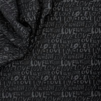 Apparel fabric with black inscription
