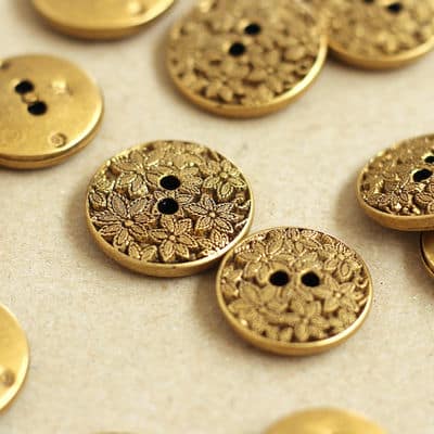 Vintage light metal button with flowers - old gold
