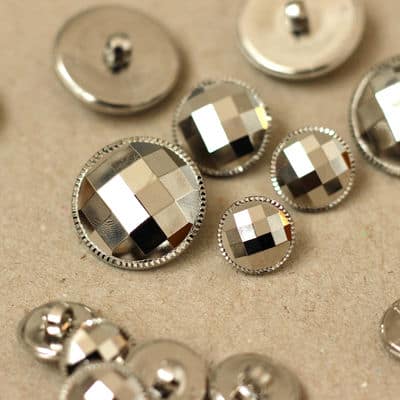 Button with facets and silver metal aspect