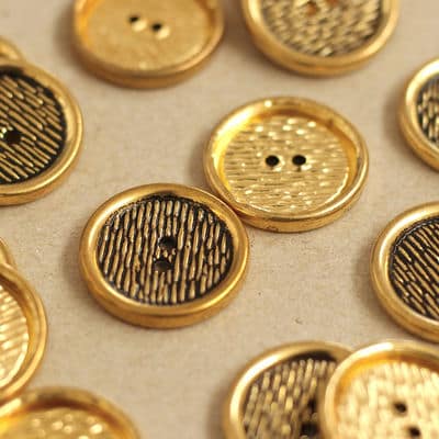 Button with golden metal aspect