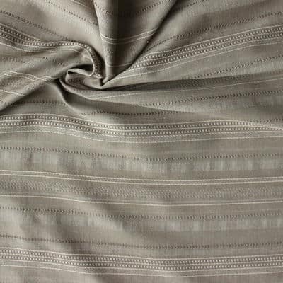 Polyester and viscose fabric with lines on kaki background