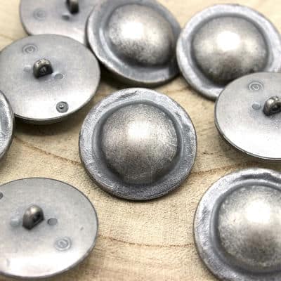 Button with silver metal aspect