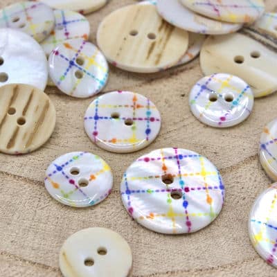 Pearly button with multicolored geometric pattern