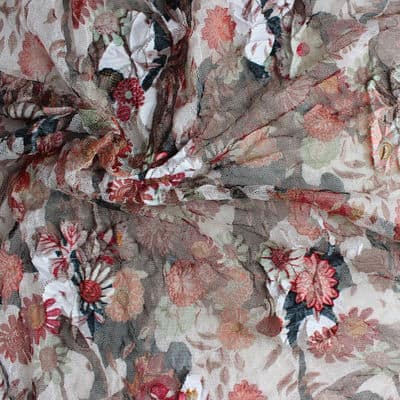 Polyester mesh fabric with red and black flowers on beige background