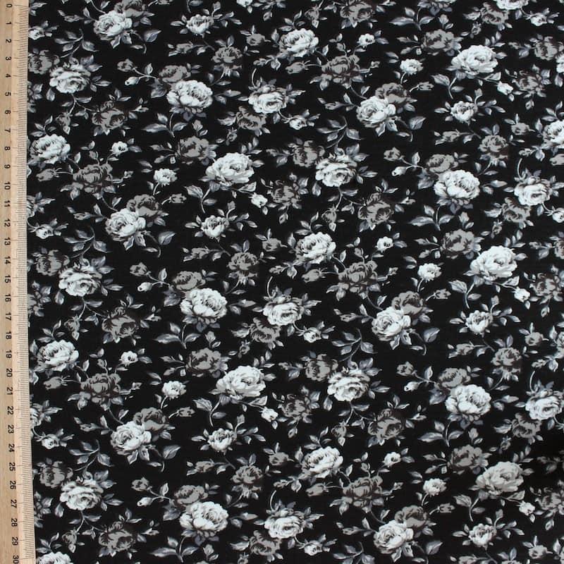 Jersey stof uit viscose en elastaan met beige bloemen op zwarte achtergrond